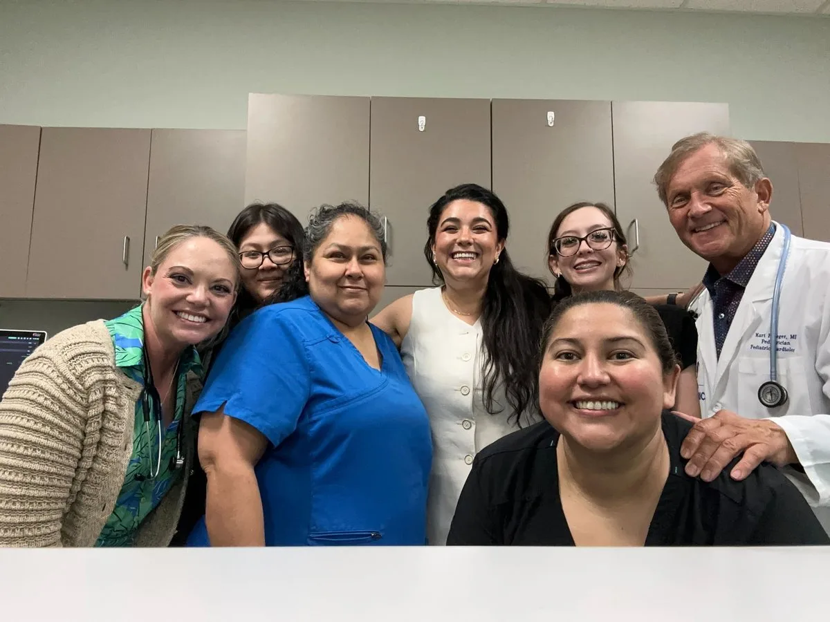 Canid team with practice staff and physician