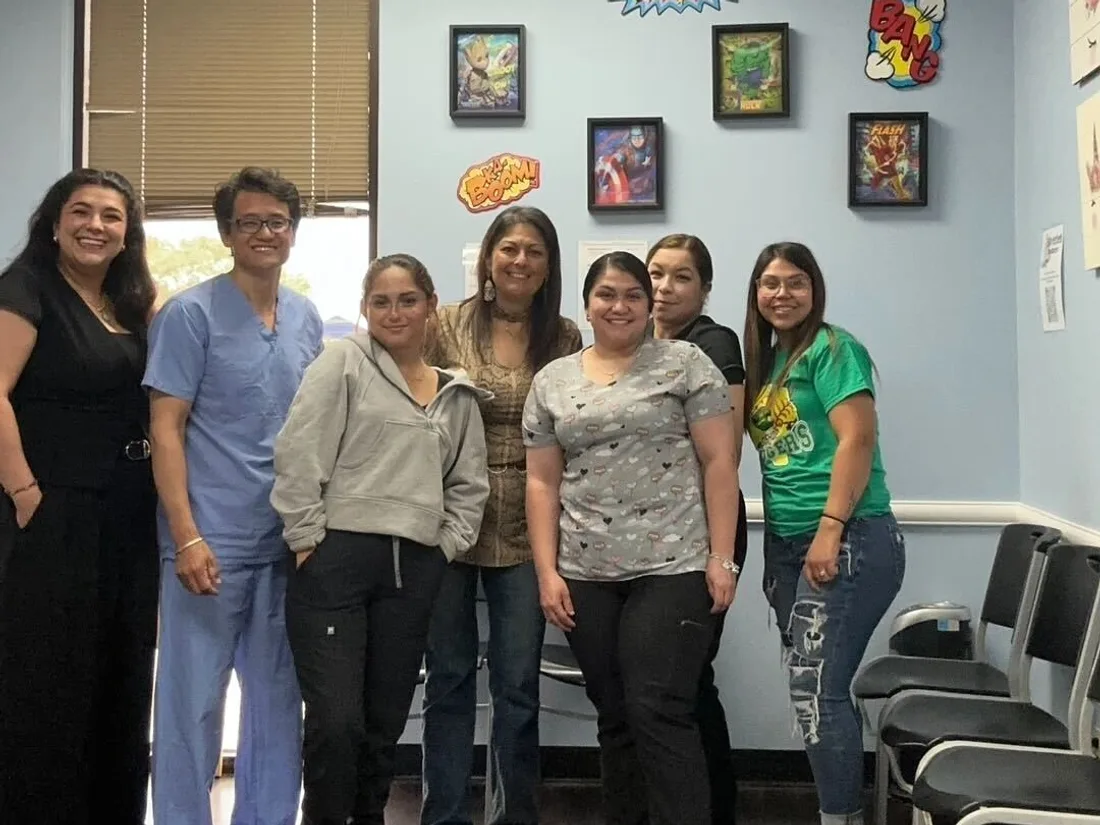 Canid team with practice staff after a visit